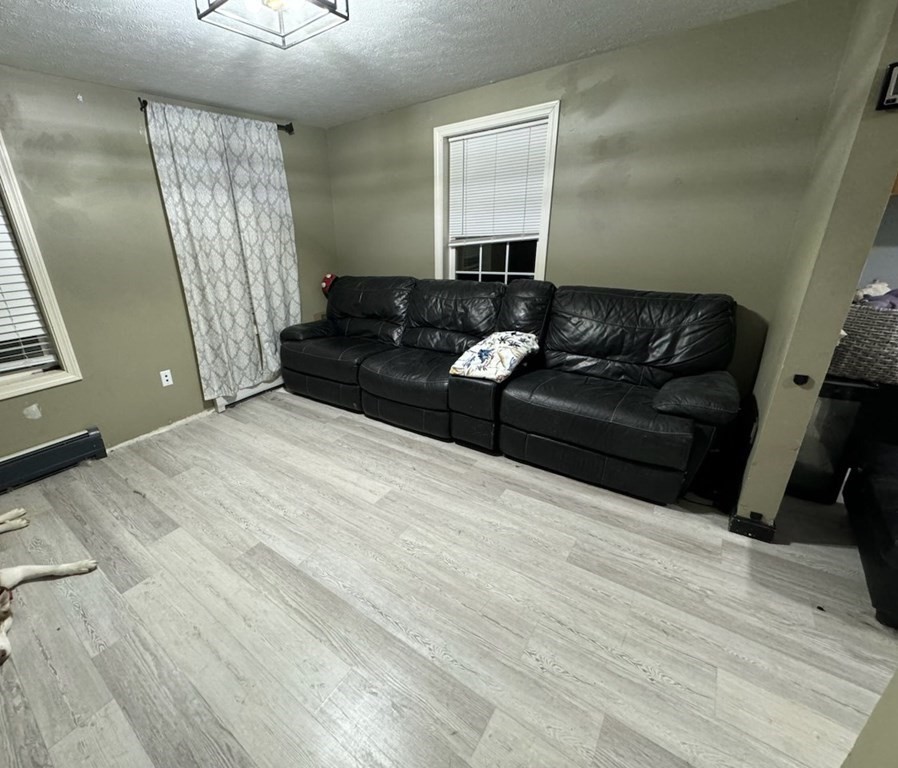 88 Lord Hill Road Rindge, NH 03461 - Photo 3 of 8 a living room with a couch and a mirror