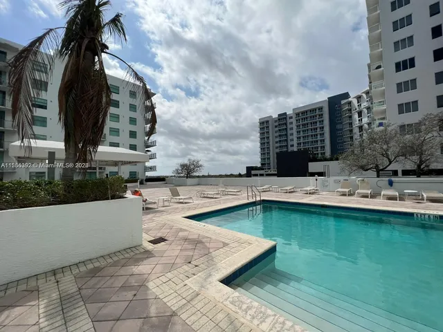 a view of swimming pool with outdoor seating and plants