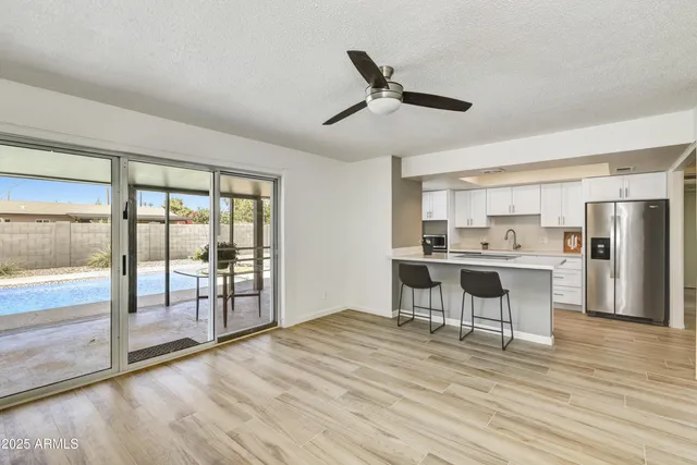 a view of a kitchen with microwave and furniture