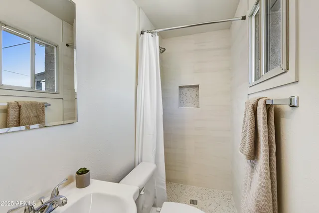 a bathroom with a shower and a toilet
