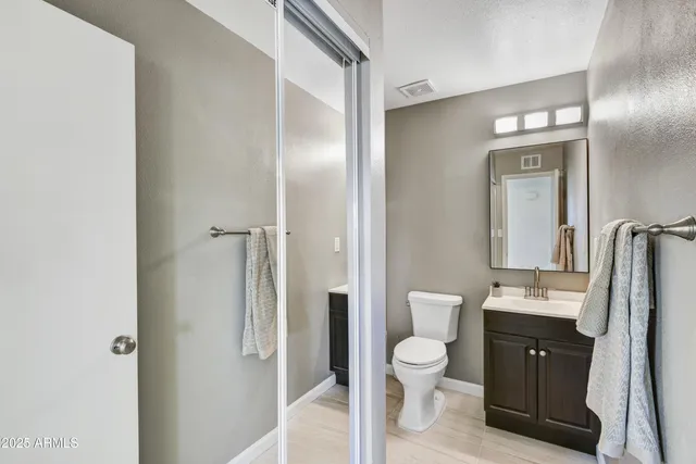 a bathroom with a toilet a sink and a mirror
