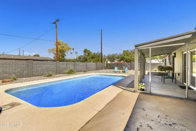 a view of a swimming pool with a lounge chair