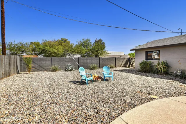 a view of a backyard with sitting area