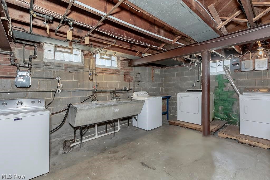 13582 Cedar Road Cleveland, OH 44118 - Photo 39 of 42 Basement featuring sink and 2 washing machines and 2 dryers
