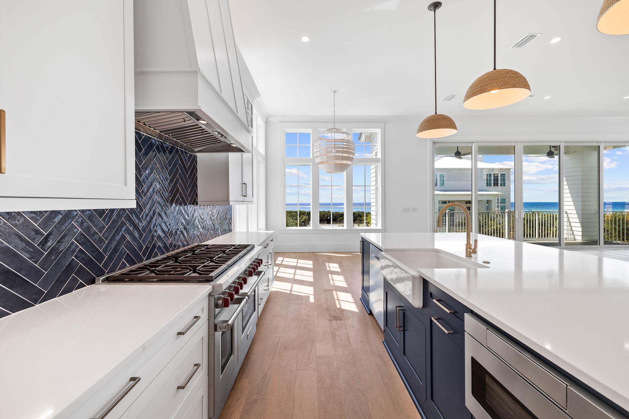 43 Pompano Street Inlet Beach, FL 32461 - Photo 19 of 83 a kitchen with kitchen island granite countertop a stove a sink a dining table and chairs