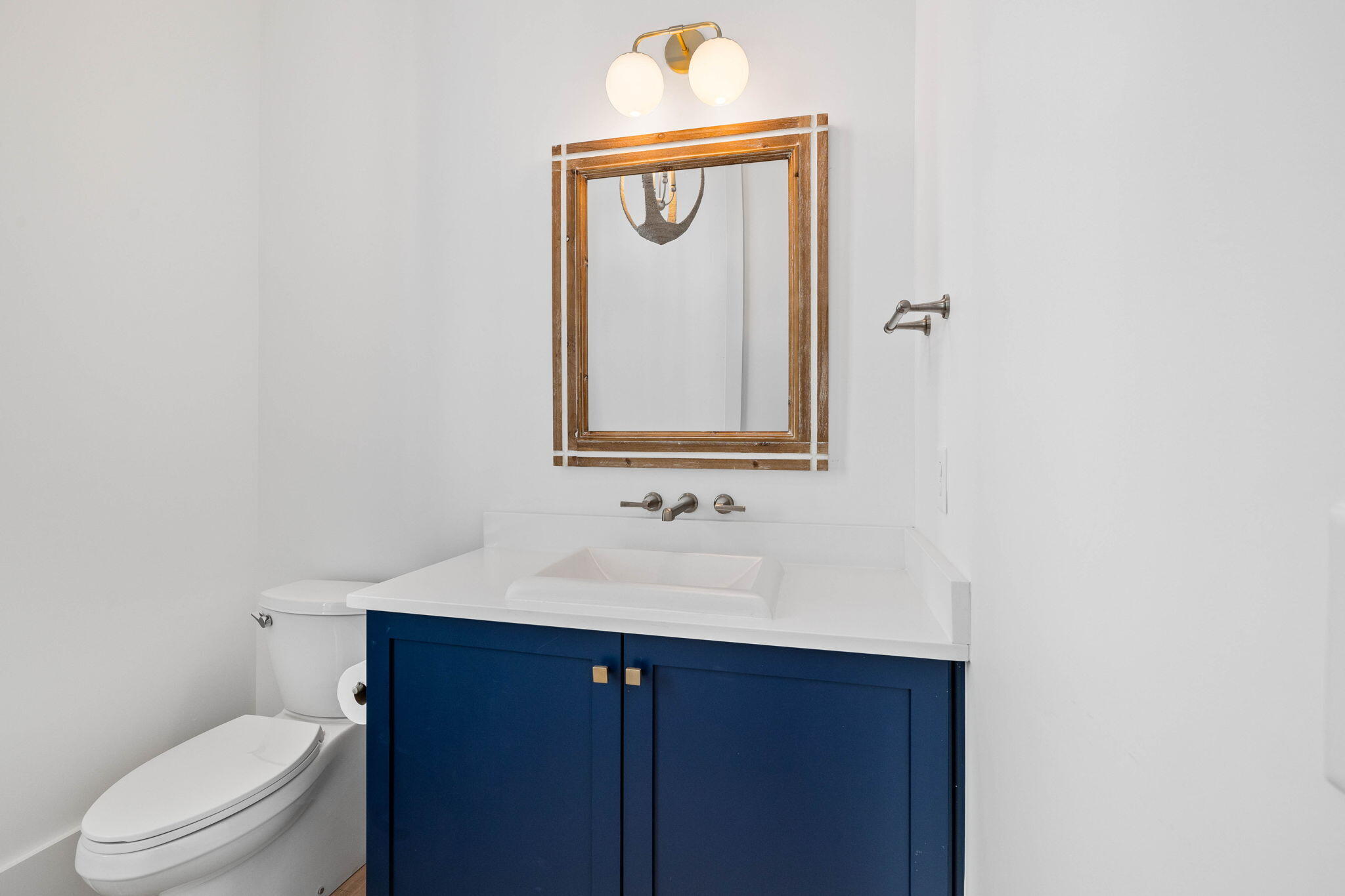 43 Pompano Street Inlet Beach, FL 32461 - Photo 59 of 83 a bathroom with a toilet sink vanity and mirror