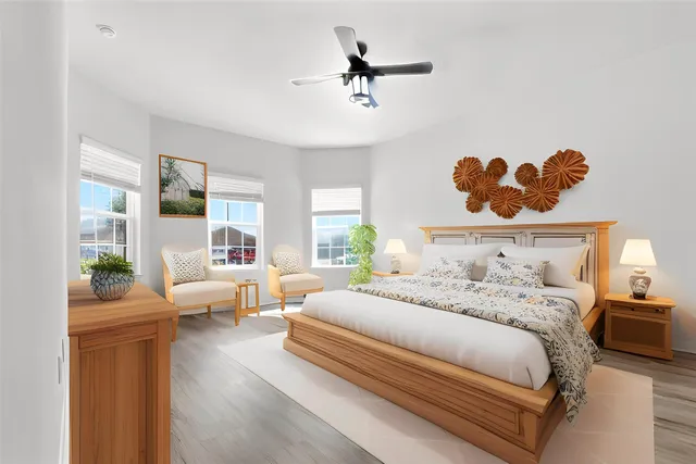an empty room with wooden floor chandelier fan and windows