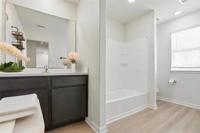 a bathroom with a bathtub and a sink