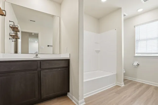 a bedroom with a bed and a potted plant