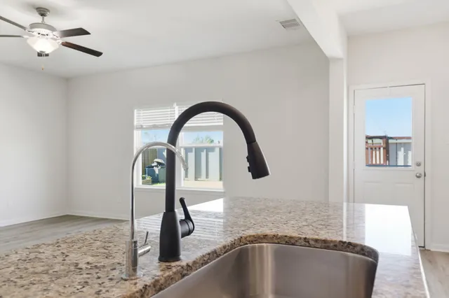 a kitchen with stainless steel appliances granite countertop a stove and a microwave