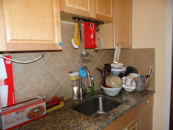 159 Sturges Street Medford, MA 02155 - Photo 3 of 12 a bathroom with a granite countertop sink a toilet and tub