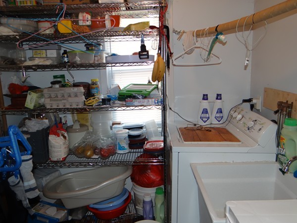 159 Sturges Street Medford, MA 02155 - Photo 4 of 12 a room with water heater and wooden cabinets