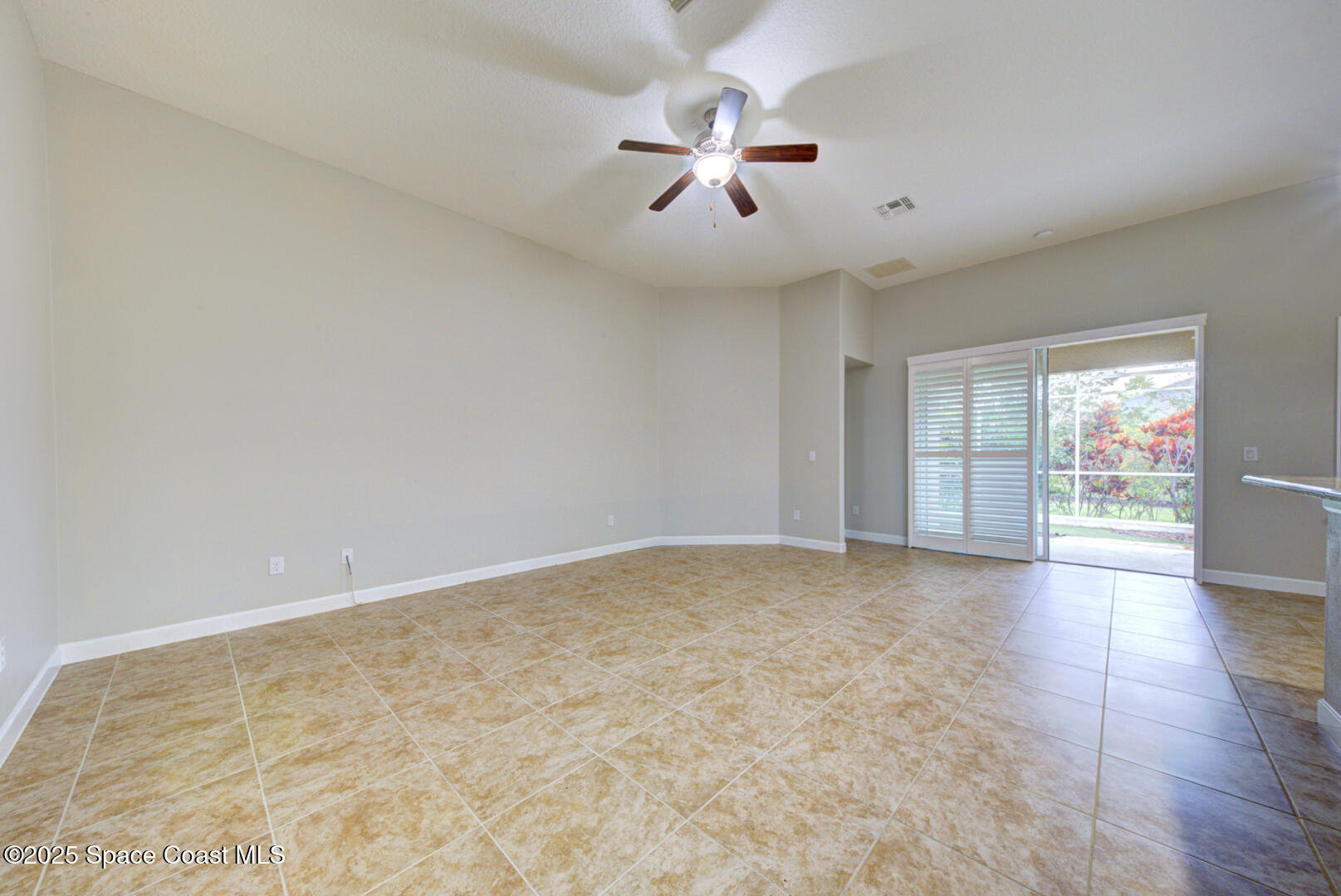 3352 Russ Place Melbourne, FL 32940 - Photo 17 of 67 an empty room with chandelier fan and windows