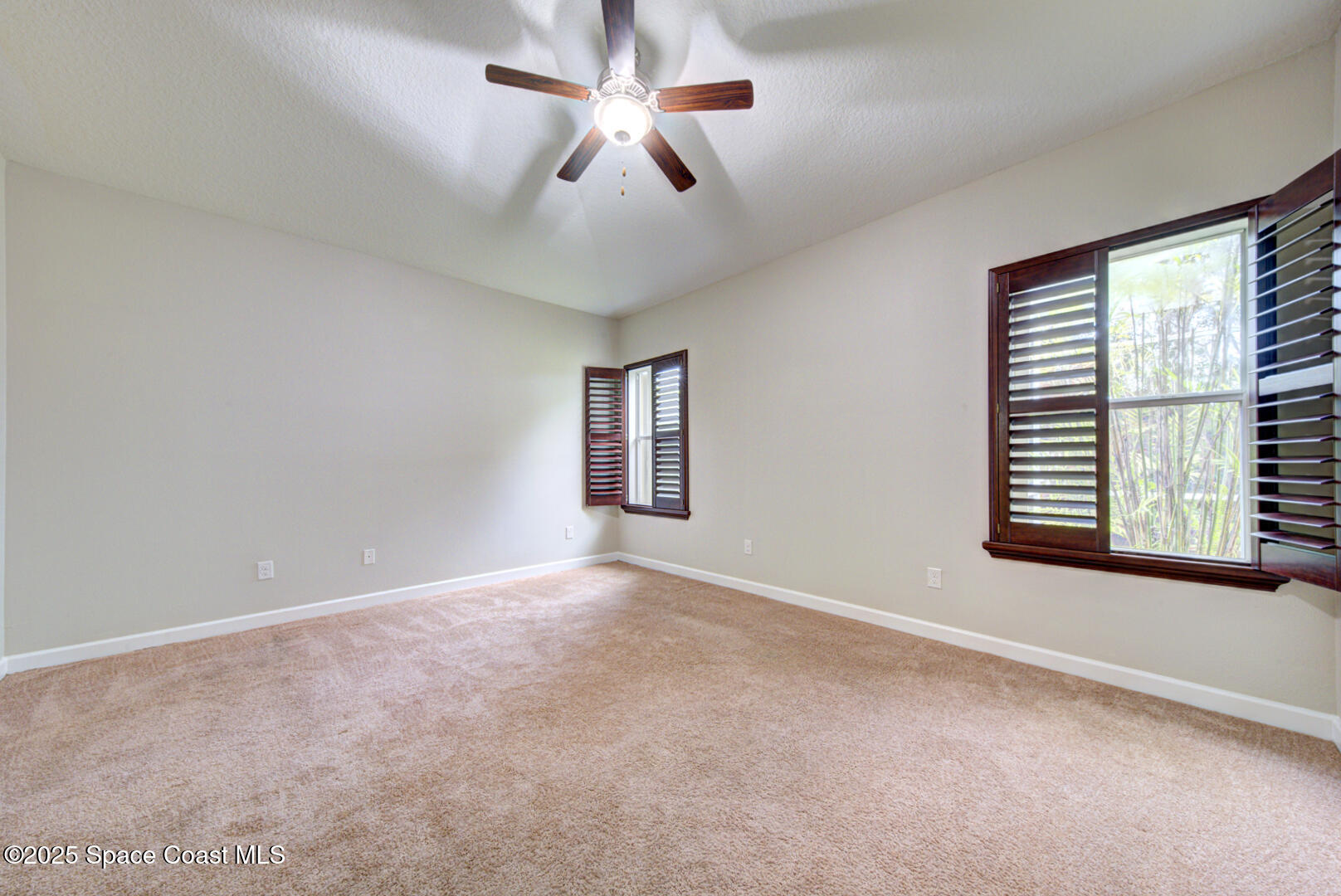 3352 Russ Place Melbourne, FL 32940 - Photo 31 of 67 an empty room with windows and fan