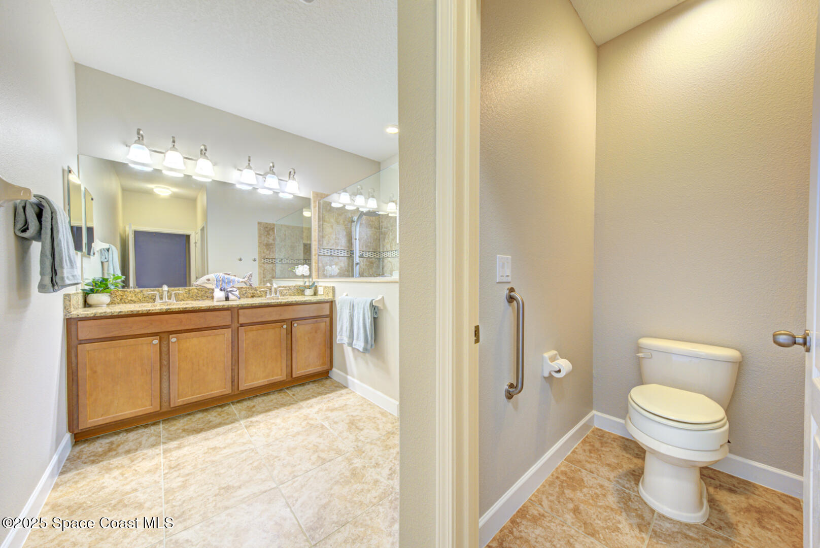 3352 Russ Place Melbourne, FL 32940 - Photo 34 of 67 a bathroom with a sink a toilet and a mirror