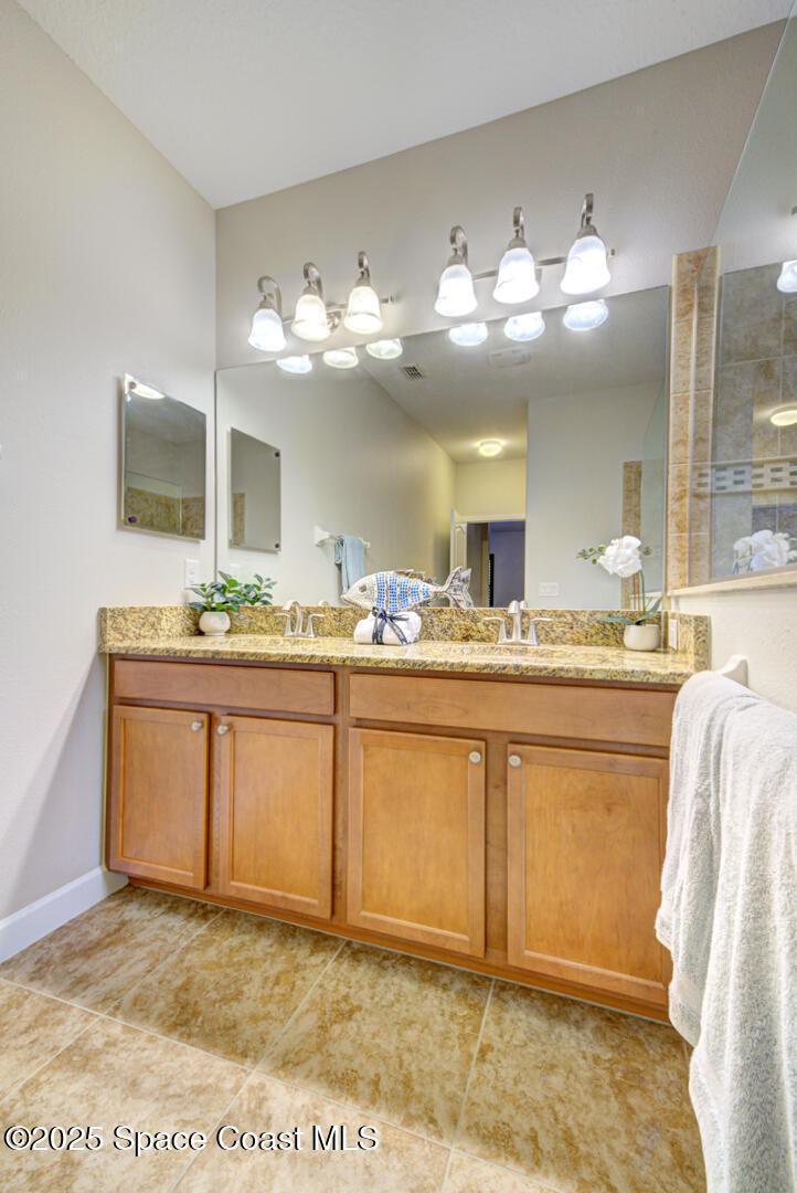 3352 Russ Place Melbourne, FL 32940 - Photo 37 of 67 a bathroom with a sink and a mirror