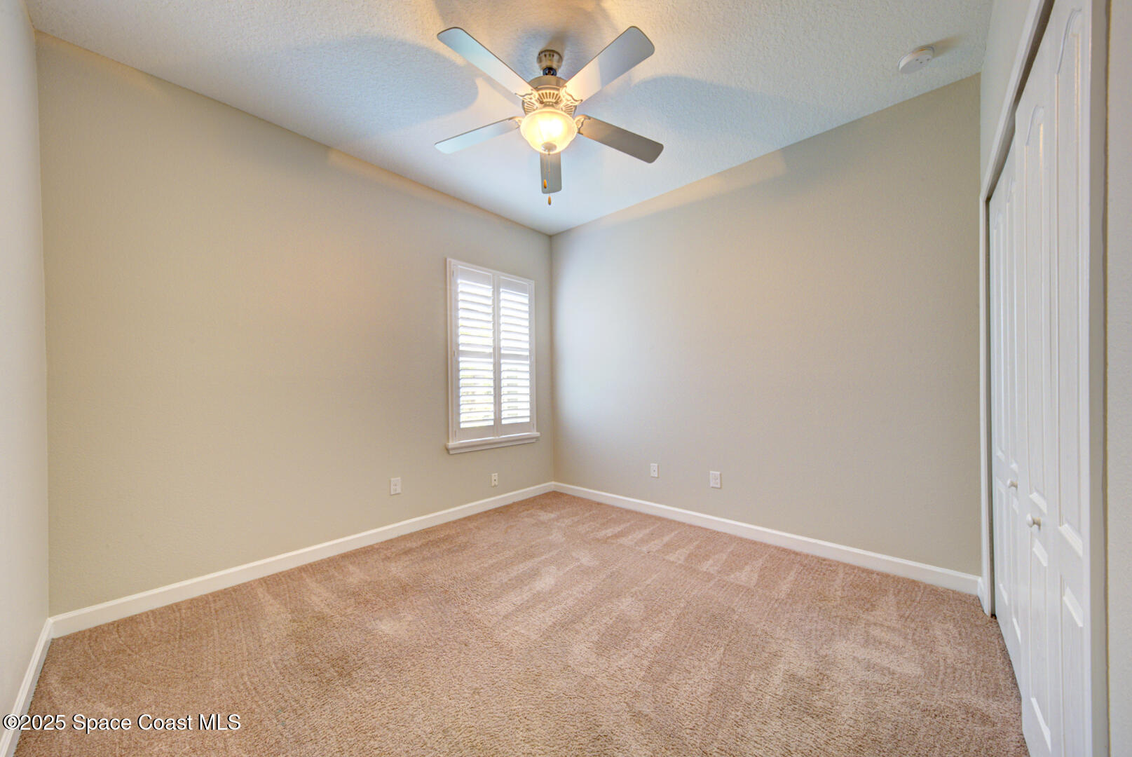3352 Russ Place Melbourne, FL 32940 - Photo 39 of 67 an empty room with windows and ceiling fan