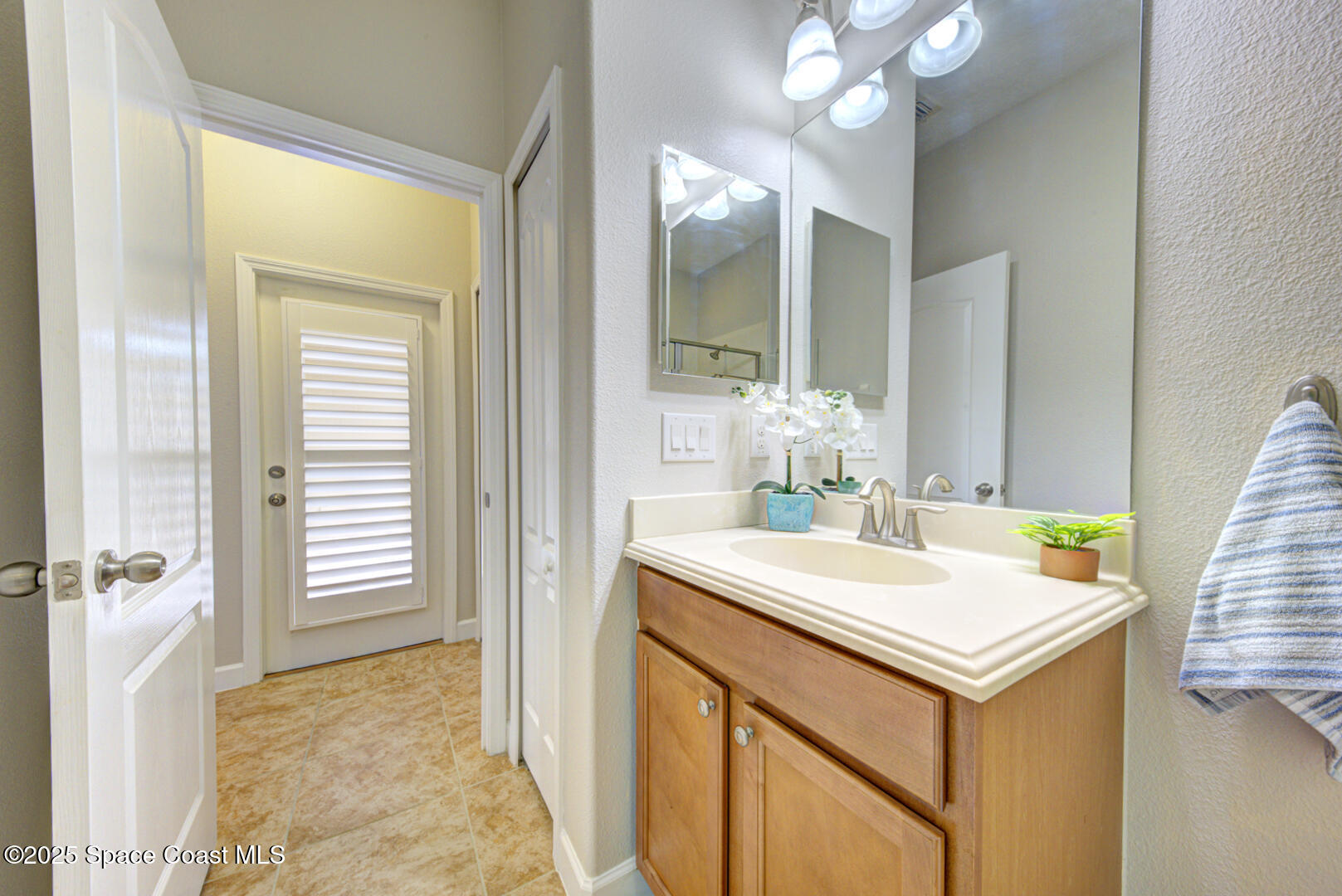3352 Russ Place Melbourne, FL 32940 - Photo 43 of 67 a bathroom with a sink vanity and a mirror