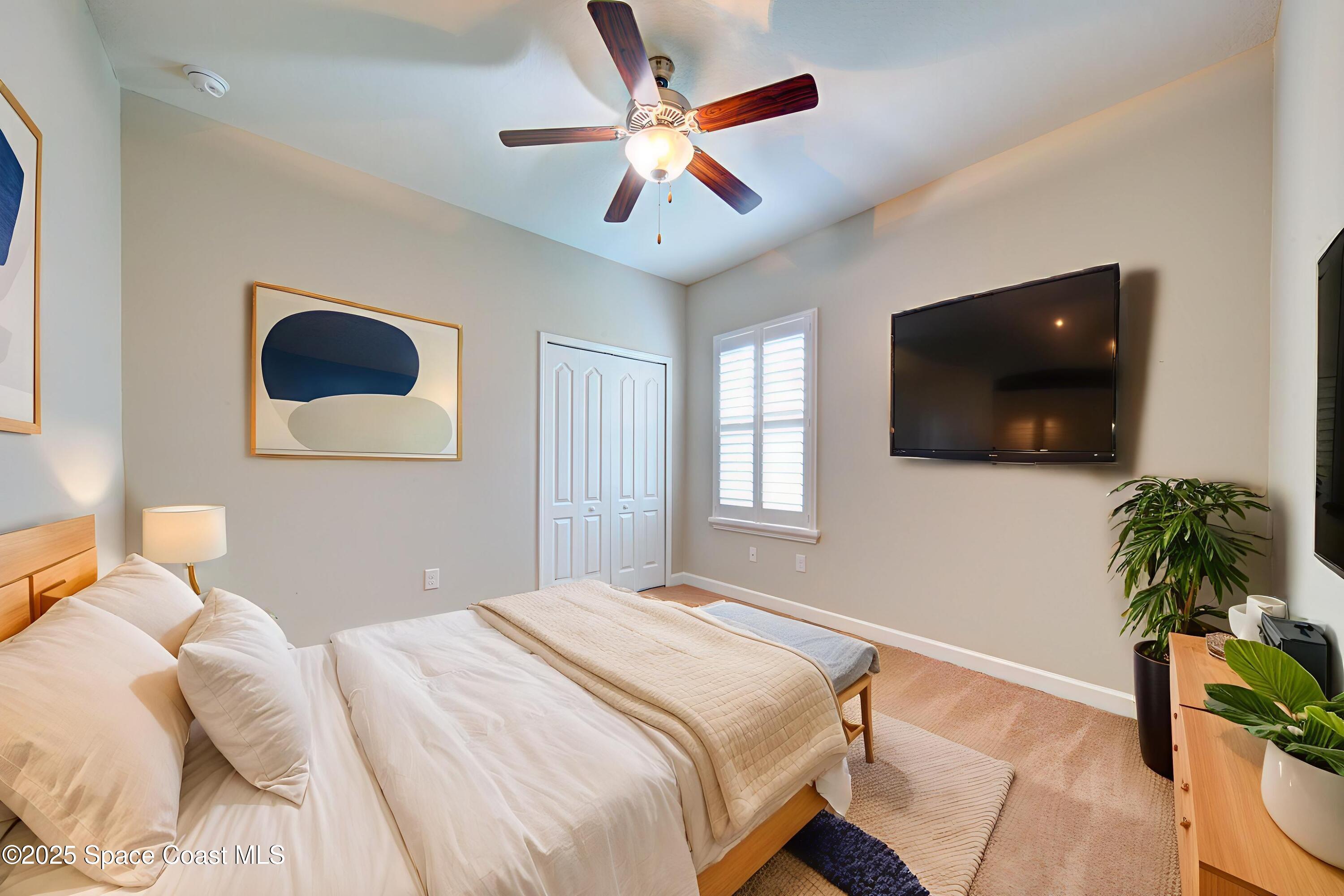 3352 Russ Place Melbourne, FL 32940 - Photo 45 of 67 a bedroom with a bed and a flat screen tv