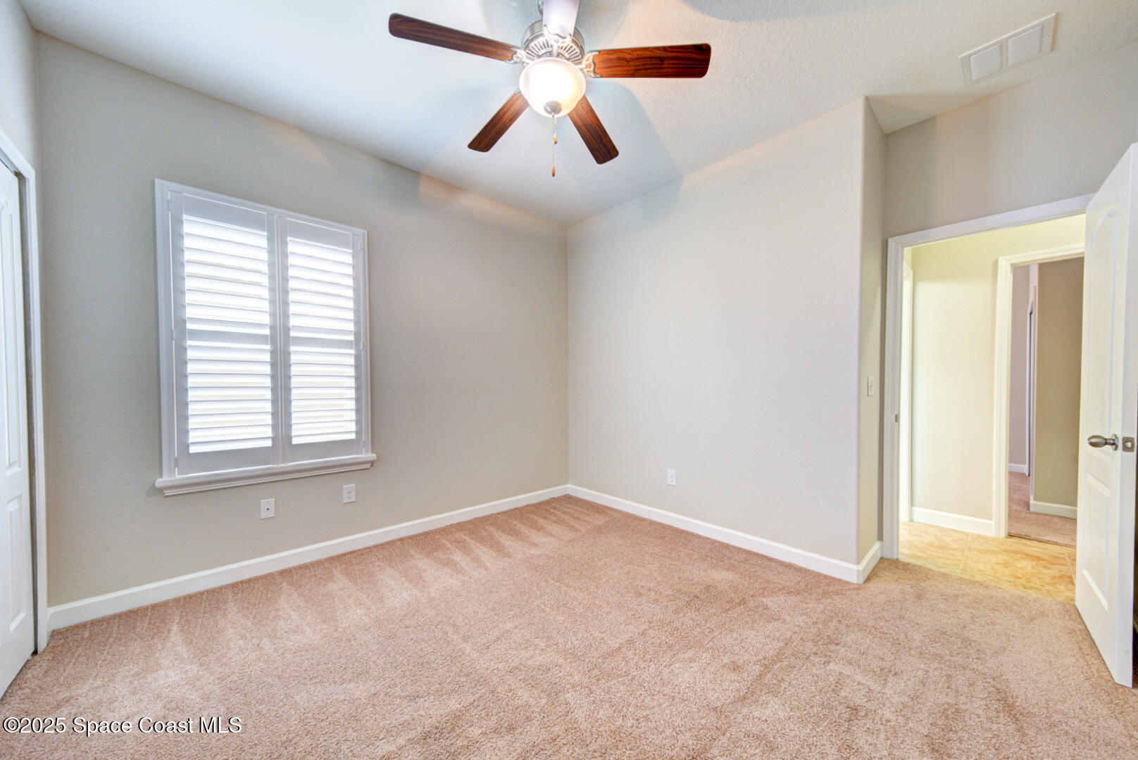3352 Russ Place Melbourne, FL 32940 - Photo 46 of 67 a view of an empty room with window and a chandelier fan