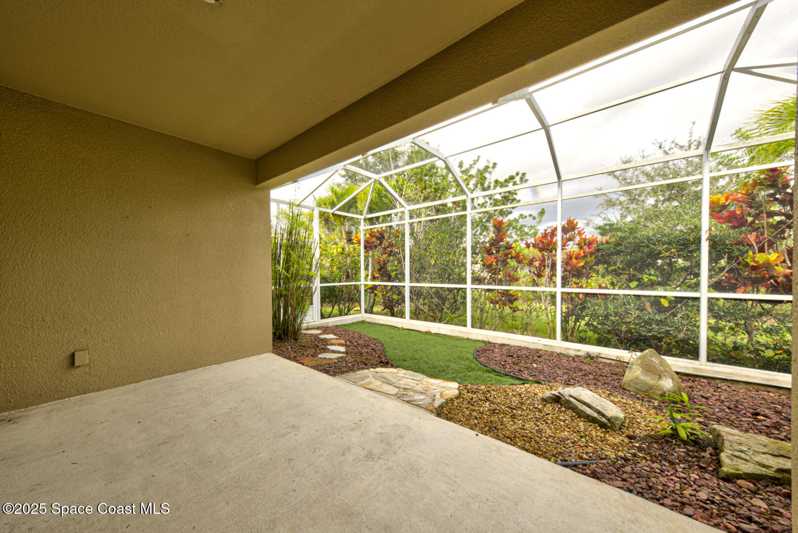 3352 Russ Place Melbourne, FL 32940 - Photo 50 of 67 a view of an empty room with a floor to ceiling window next to a yard