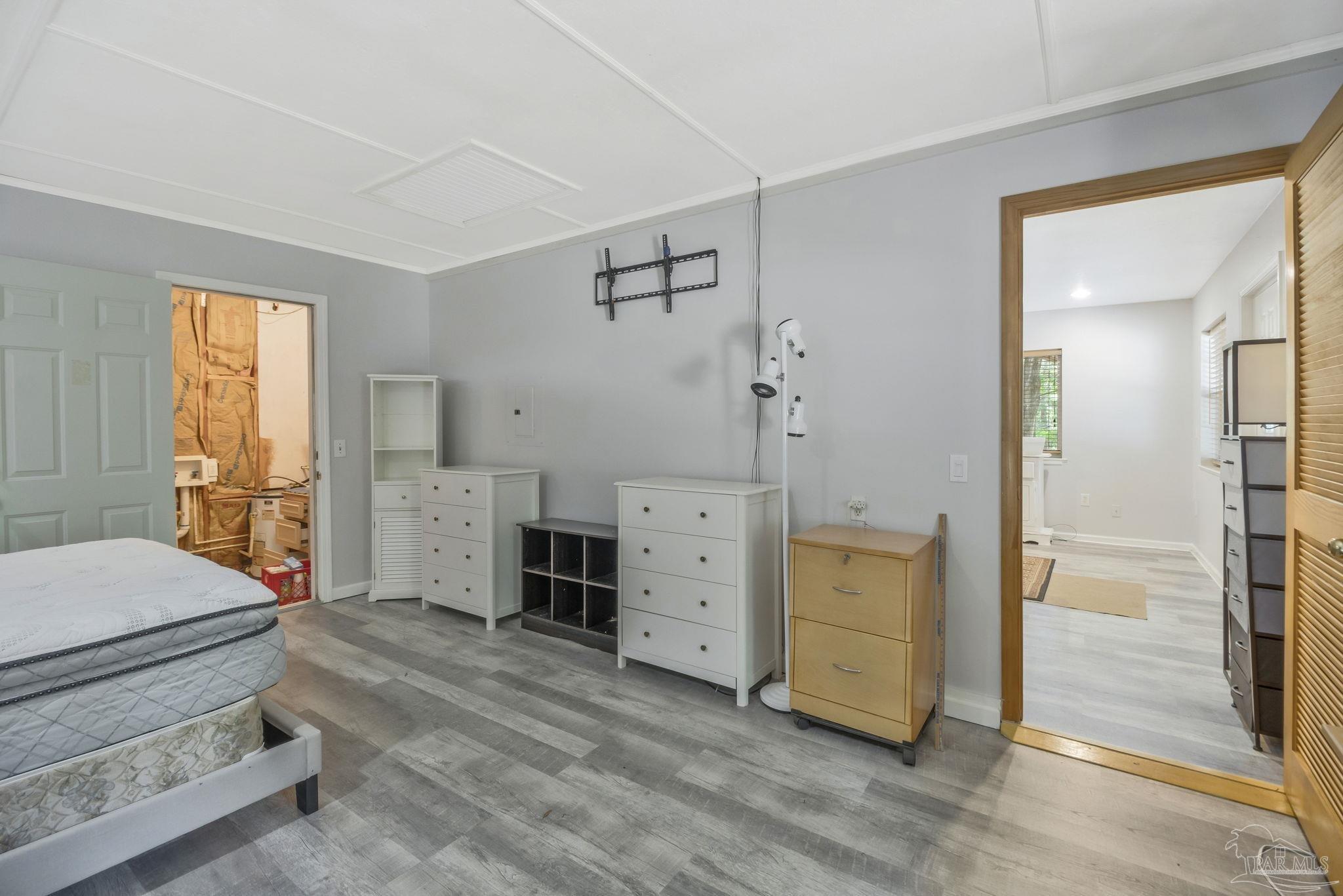 10290 West Lake Road Milton, FL 32583 - Photo 12 of 53 a room with a dresser and a window