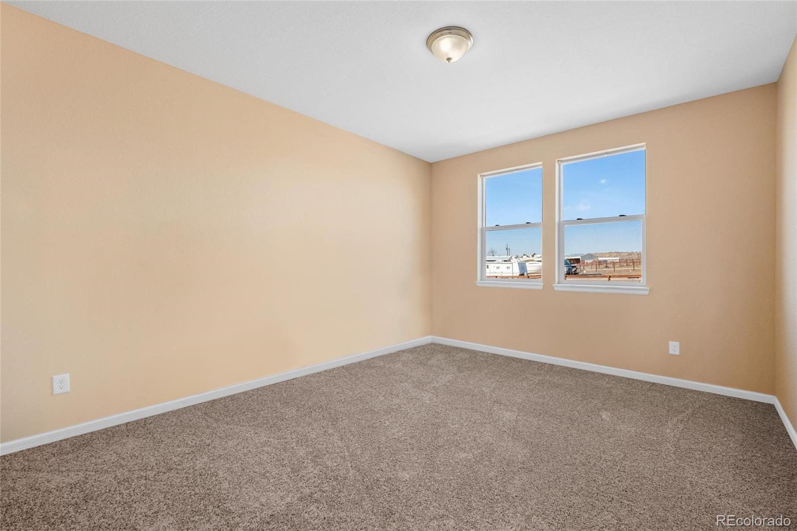 1445 4th Place Deer Trail, CO 80105 - Photo 13 of 19 an empty room with windows