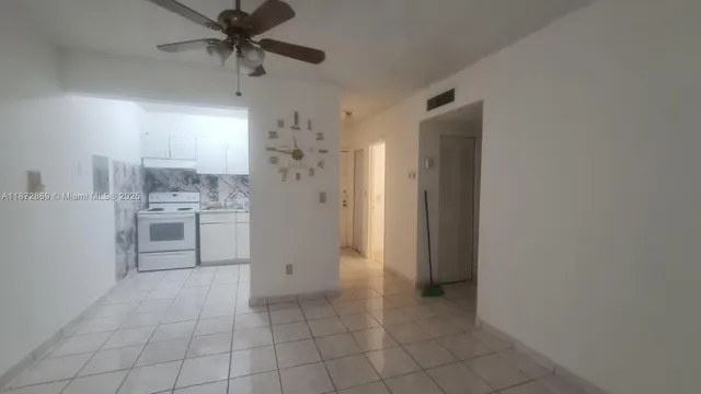 a kitchen with granite countertop a refrigerator and a stove top oven