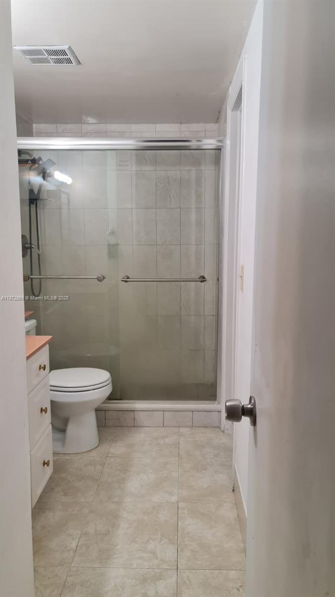 3640 Northwest 9th Street, Unit 105 Miami, FL 33125 - Photo 17 of 31 a bathroom with a toilet and a shower