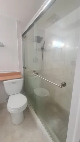 a view of a house with wooden fence and a bench