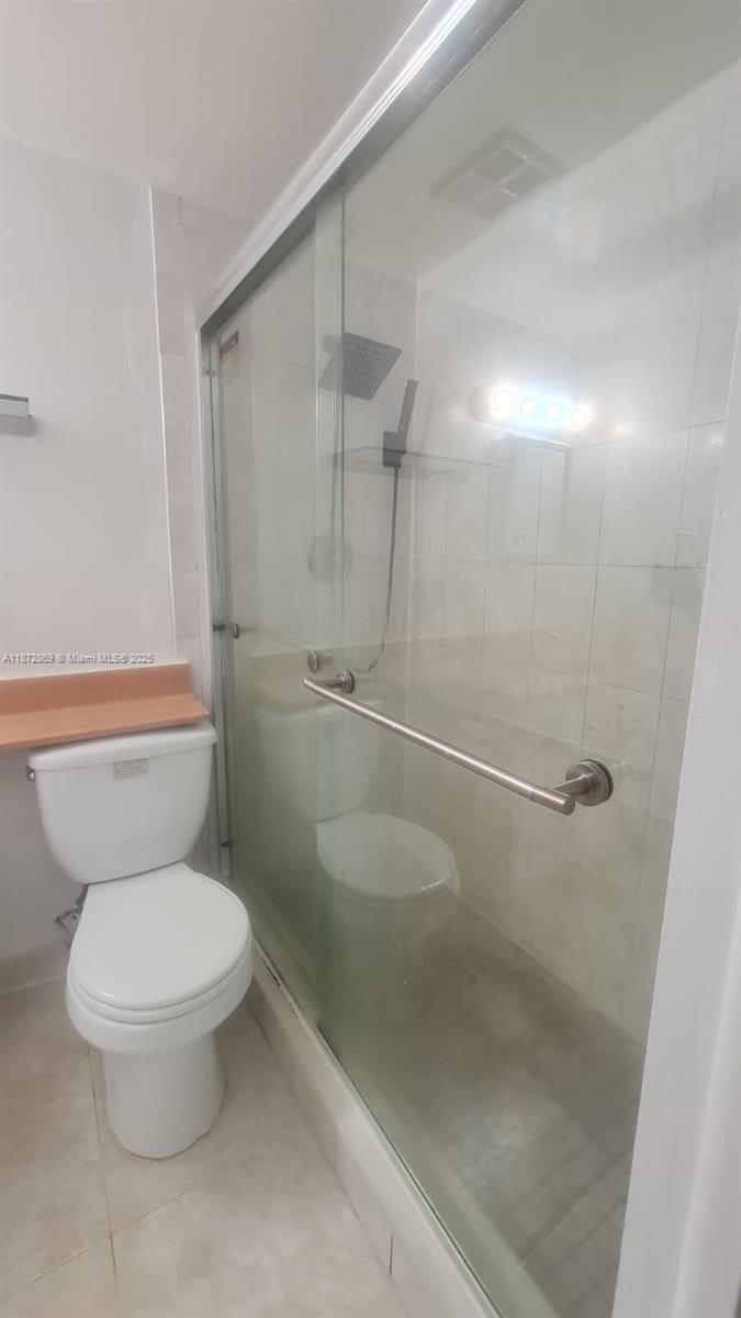 3640 Northwest 9th Street, Unit 105 Miami, FL 33125 - Photo 18 of 31 a white toilet sitting next to a bathroom sink