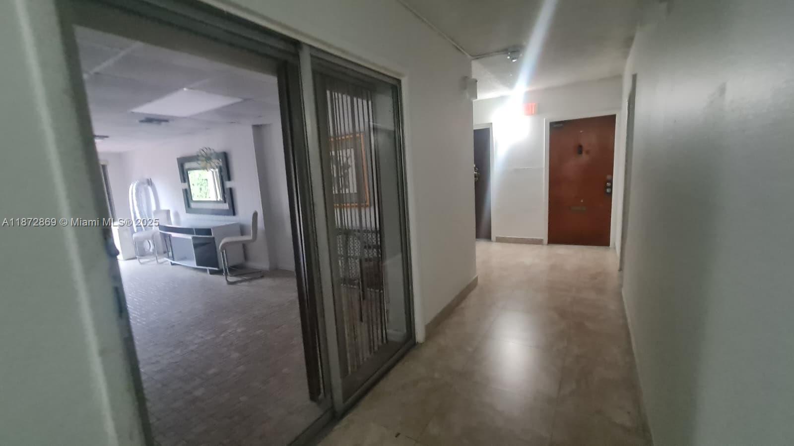 3640 Northwest 9th Street, Unit 105 Miami, FL 33125 - Photo 23 of 31 a view of a hallway view with wooden floor and a bathroom