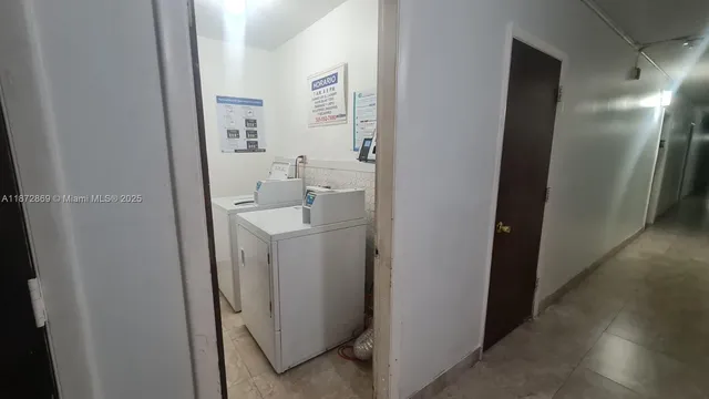 a view of swimming pool with seating area and trees in the background