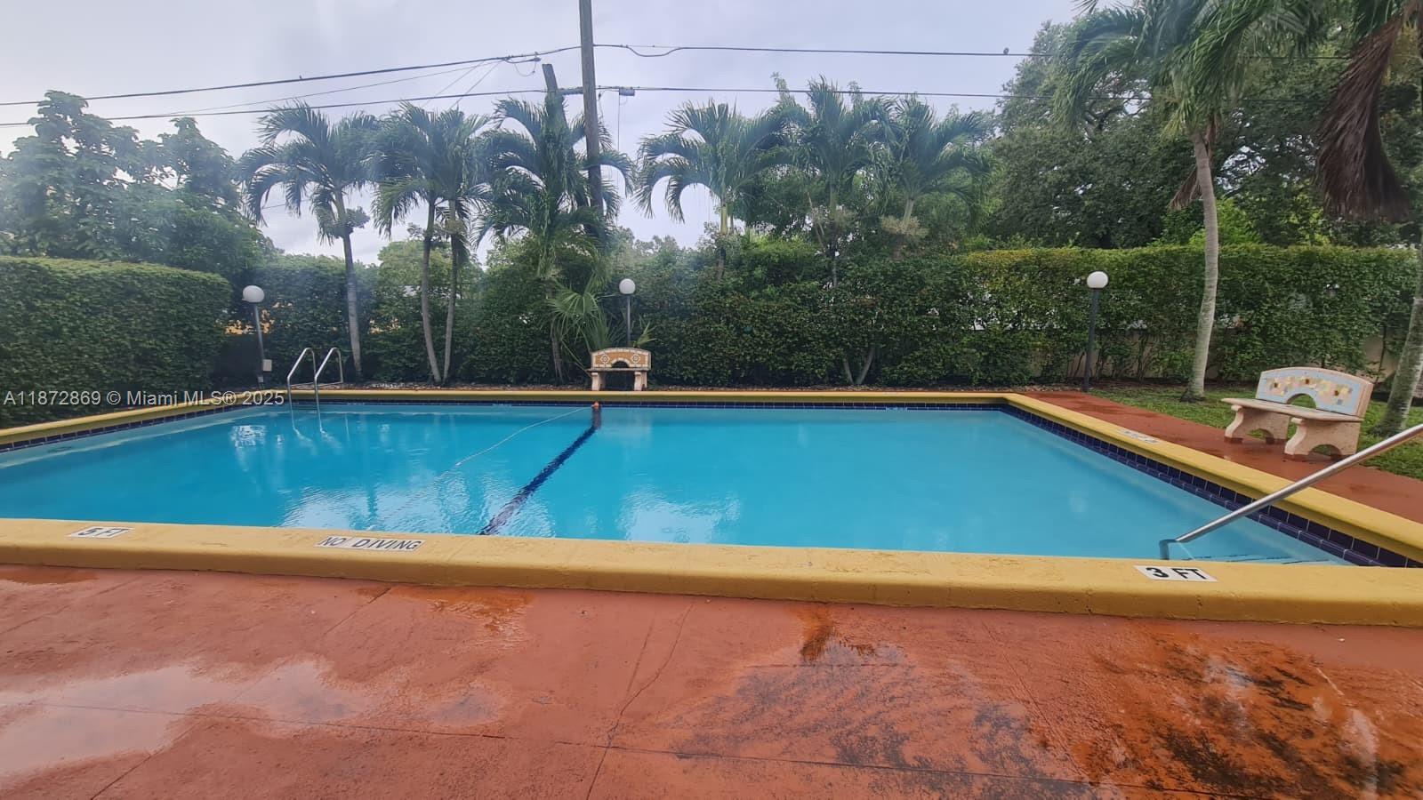 3640 Northwest 9th Street, Unit 105 Miami, FL 33125 - Photo 25 of 31 a view of a pool with a yard