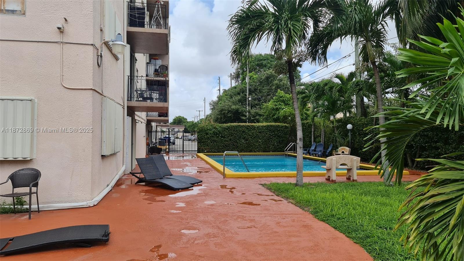 3640 Northwest 9th Street, Unit 105 Miami, FL 33125 - Photo 27 of 31 a view of a swimming pool with a bench and trees