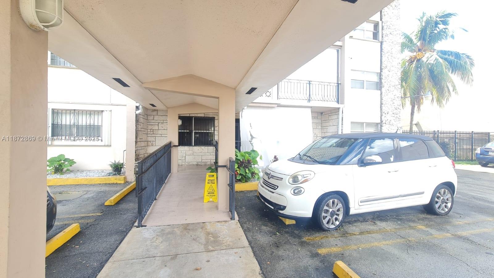 3640 Northwest 9th Street, Unit 105 Miami, FL 33125 - Photo 6 of 31 a car parked in front of house