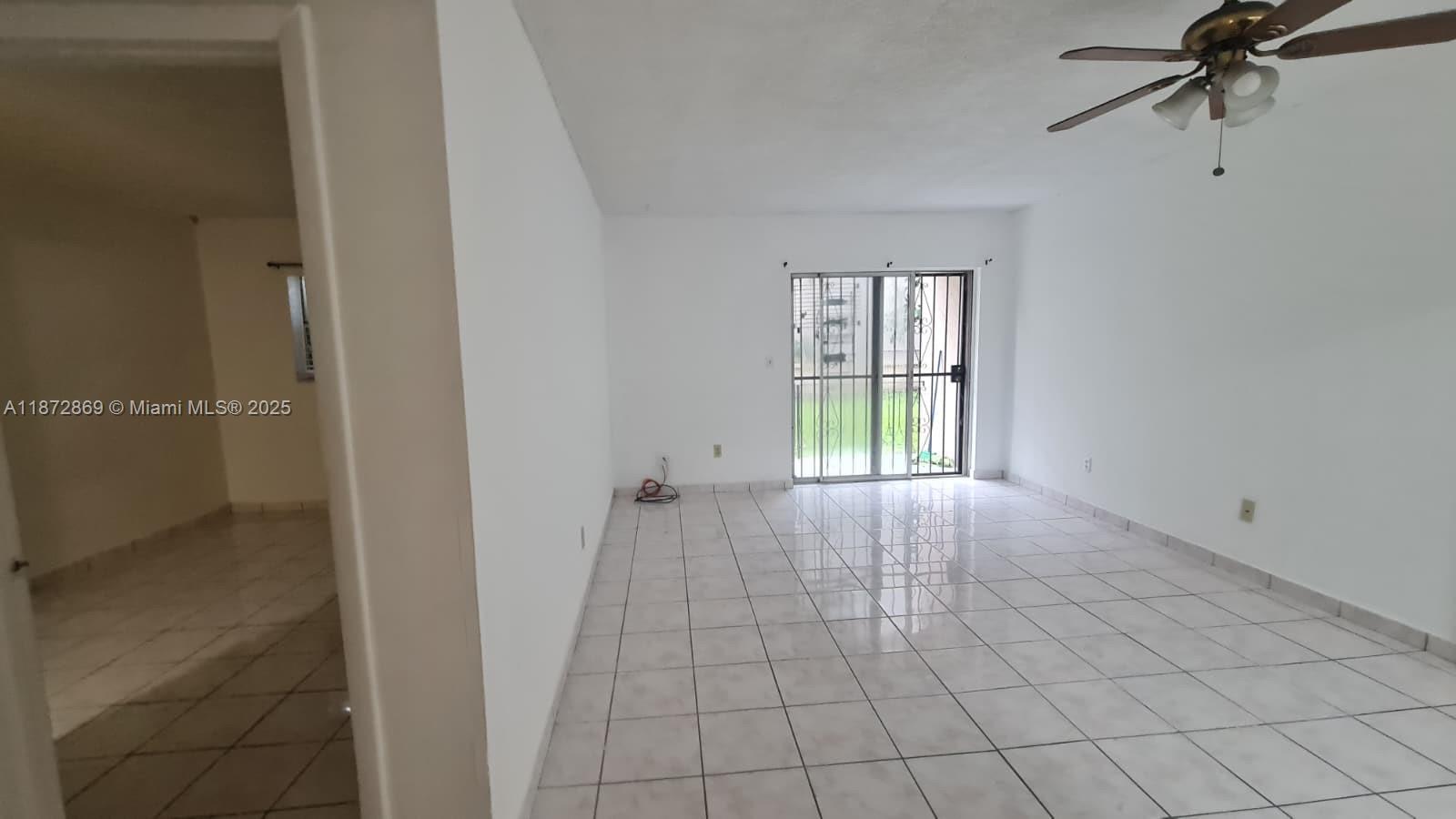 3640 Northwest 9th Street, Unit 105 Miami, FL 33125 - Photo 9 of 31 a view of an empty room with a window