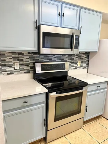 a kitchen with a stove and a microwave
