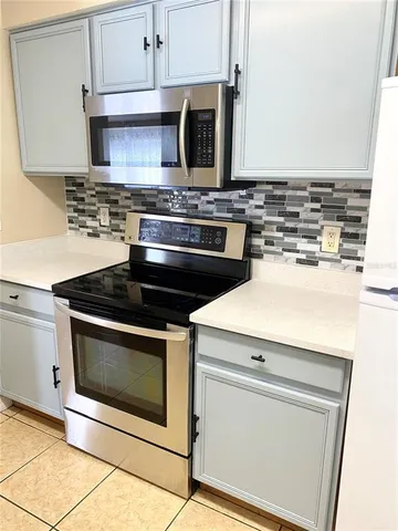 a stove top oven sitting inside of a kitchen