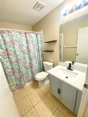 a bathroom with a sink mirror vanity and toilet