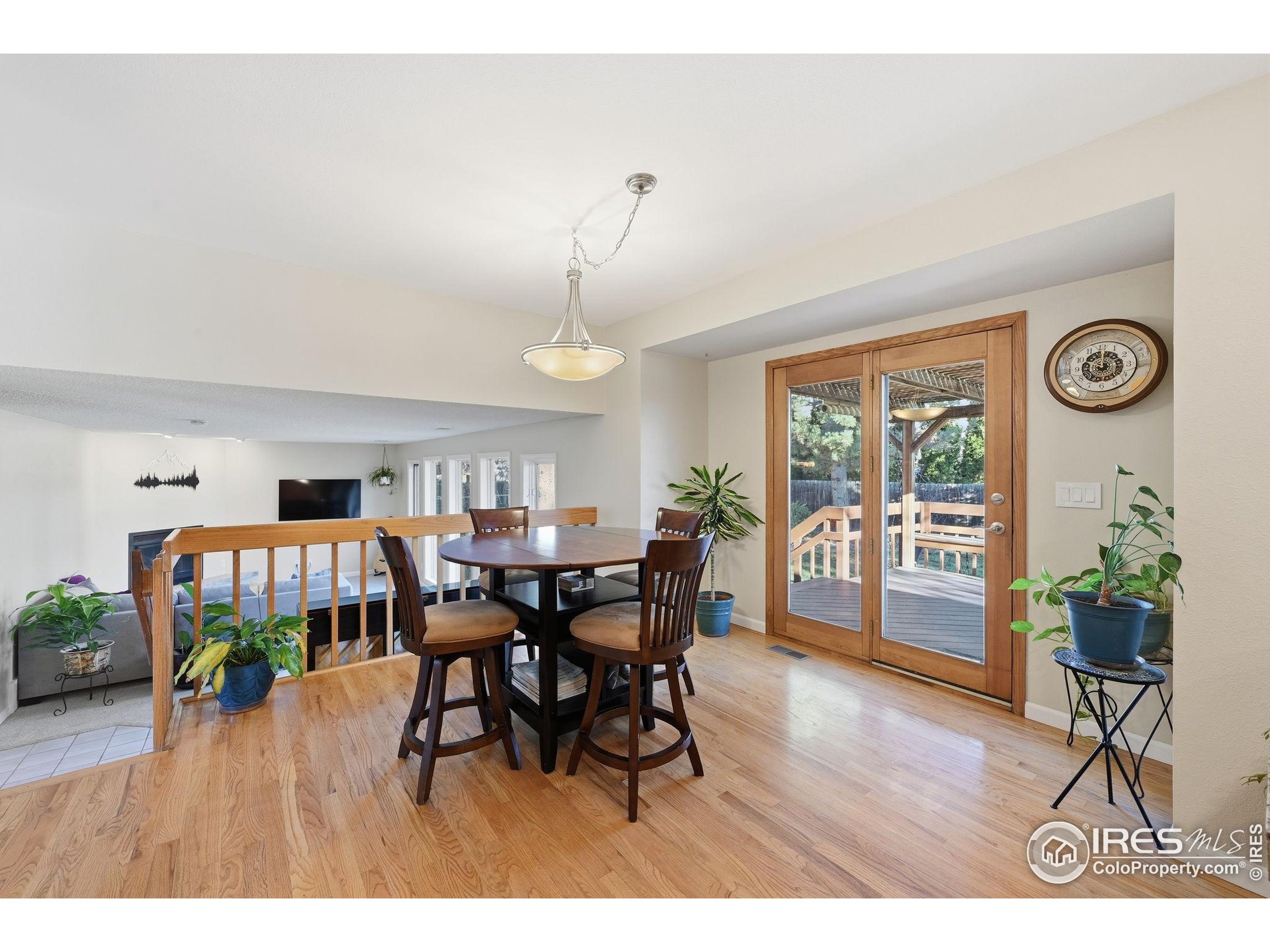 2158 Rockspray Court Longmont, CO 80503 - Photo 11 of 35 a dining room with furniture and wooden floor