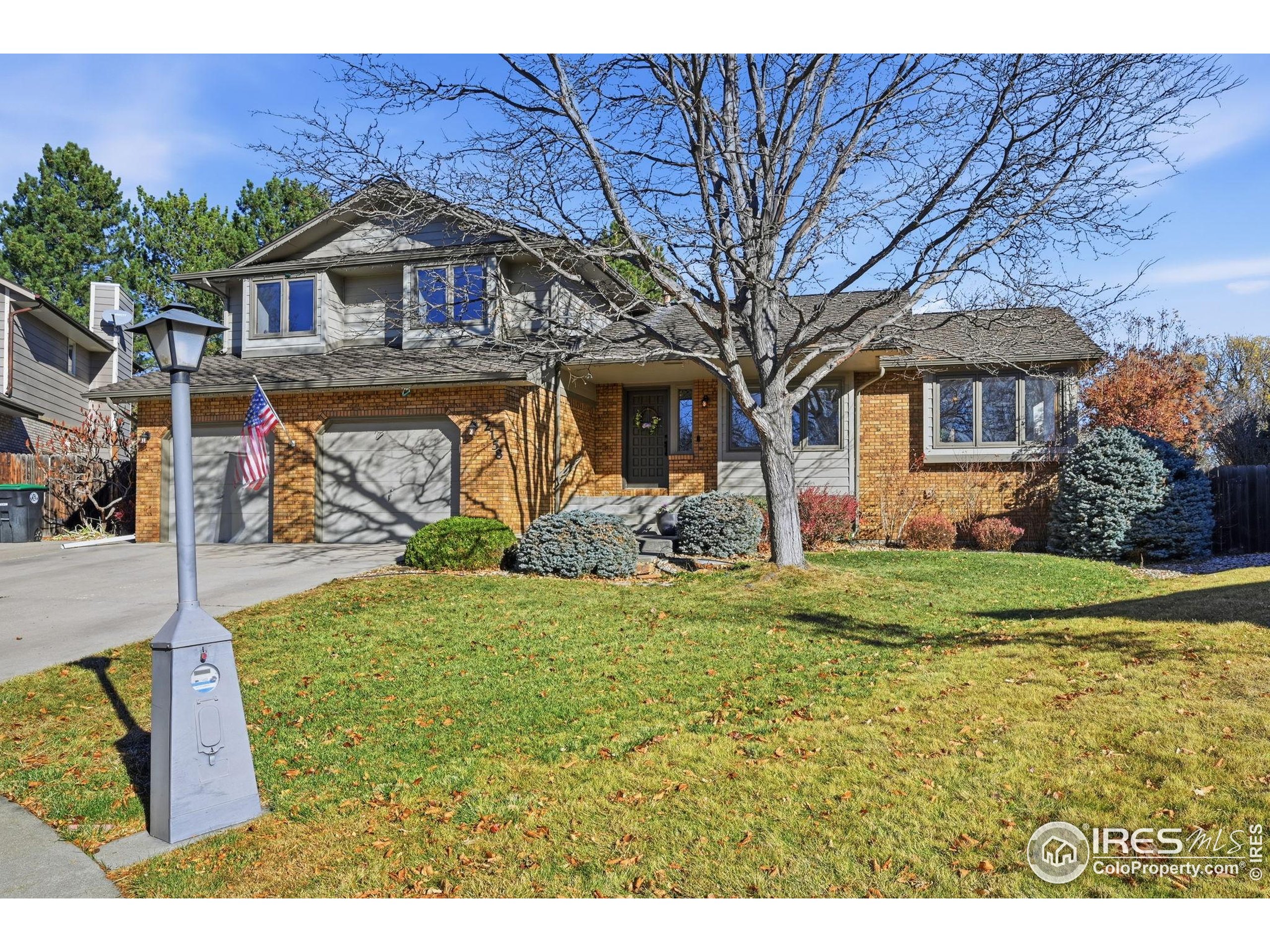 2158 Rockspray Court Longmont, CO 80503 - Photo 2 of 35 a front view of a house with garden