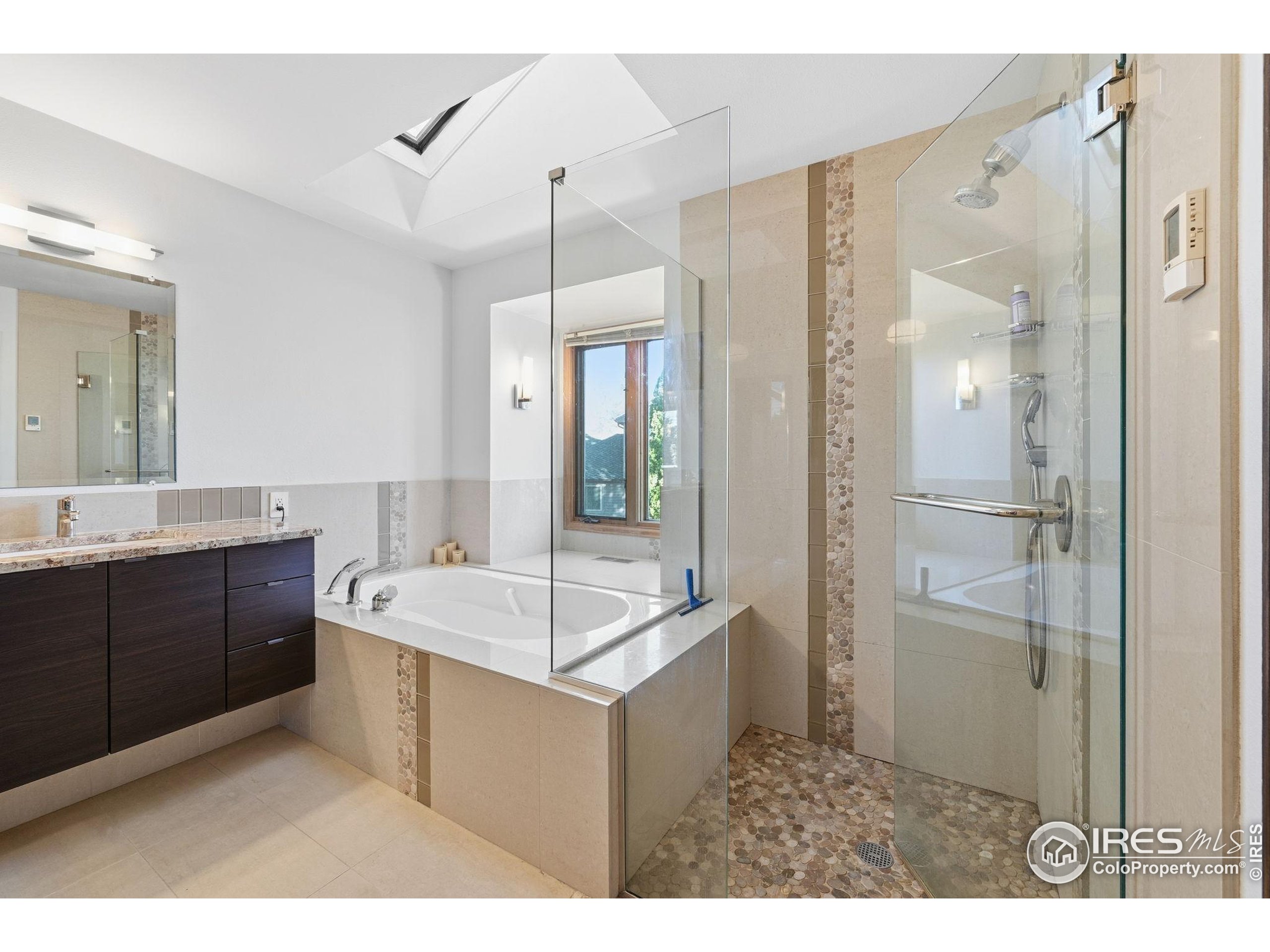 2158 Rockspray Court Longmont, CO 80503 - Photo 30 of 35 a bathroom with a sink mirror and a shower