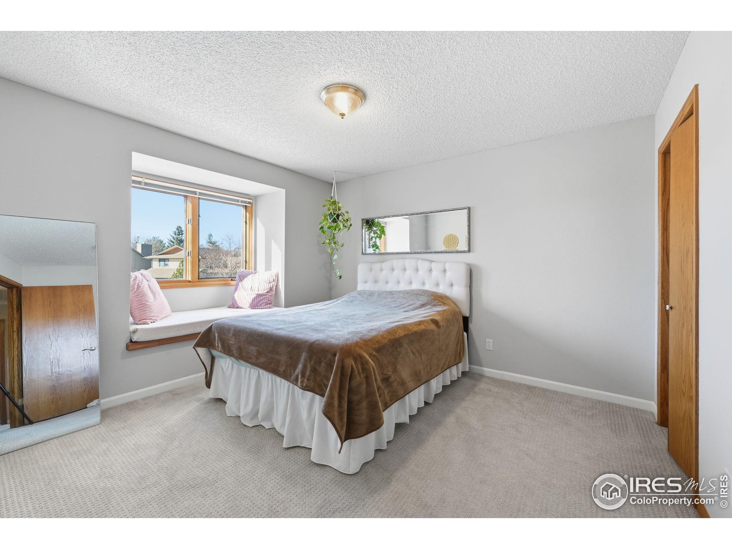 2158 Rockspray Court Longmont, CO 80503 - Photo 31 of 35 a spacious bedroom with a bed and a window