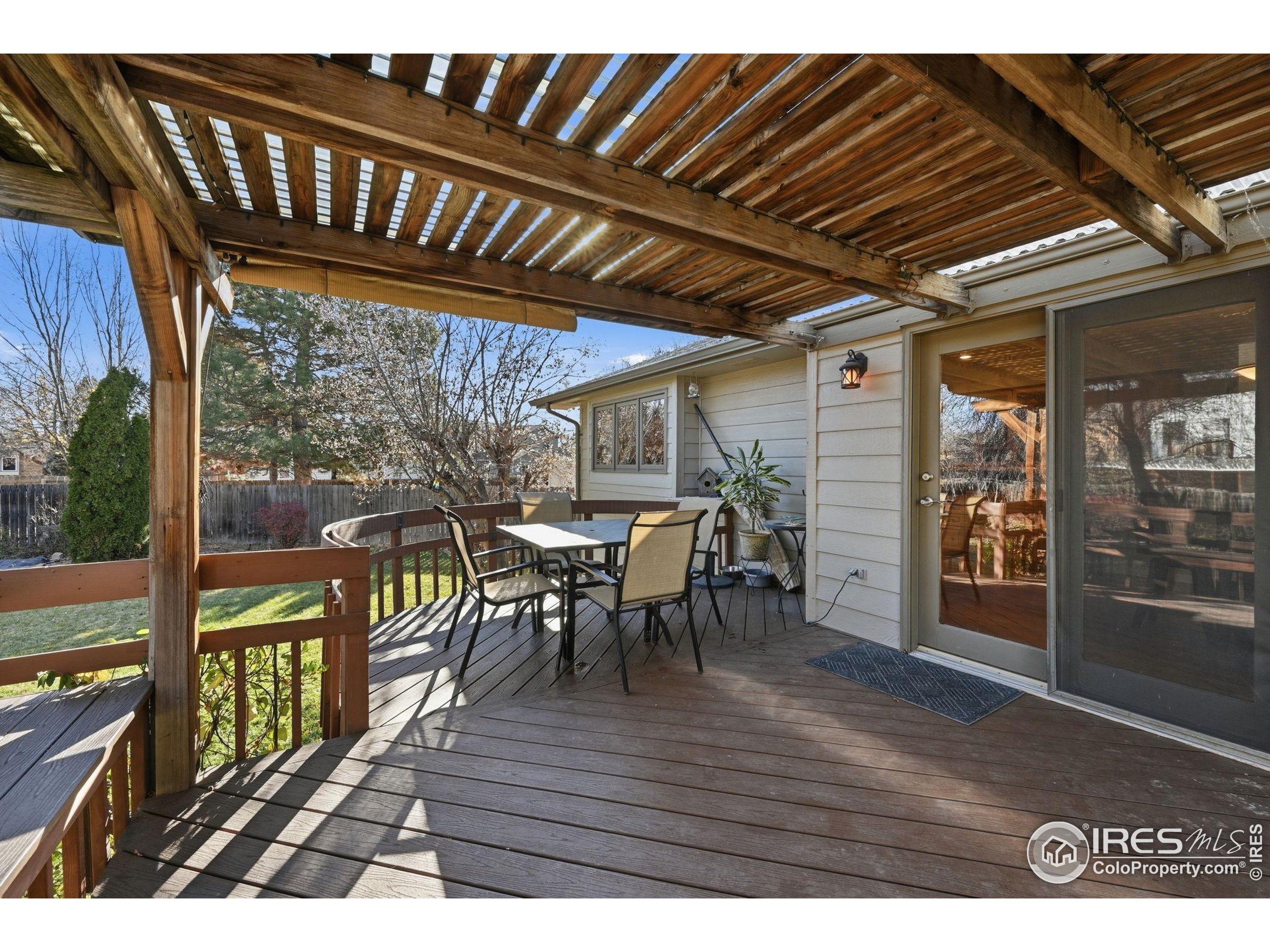 2158 Rockspray Court Longmont, CO 80503 - Photo 33 of 35 a view of a porch with furniture and wooden floor