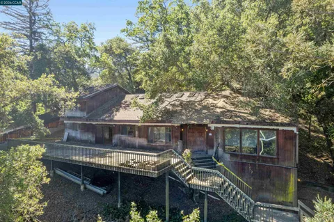 a view of backyard with barbeque grill and outdoor seating