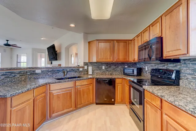 a view of a glass door with a tree in the room