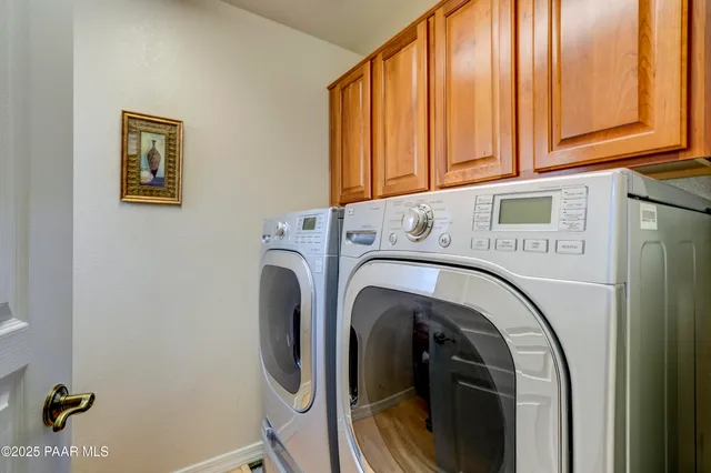 a spacious bathroom with a double vanity sink a mirror and a shower