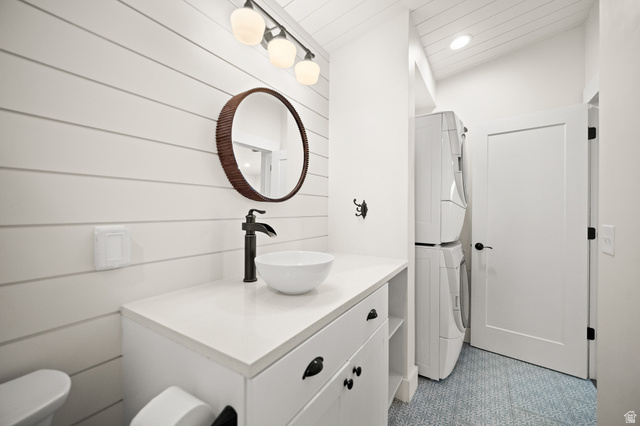 236 West 300 South Hurricane, UT 84737 - Photo 53 of 76 White shiplap accent wall with a circular mirror, a white vessel sink on a white countertop, and a matte black faucet