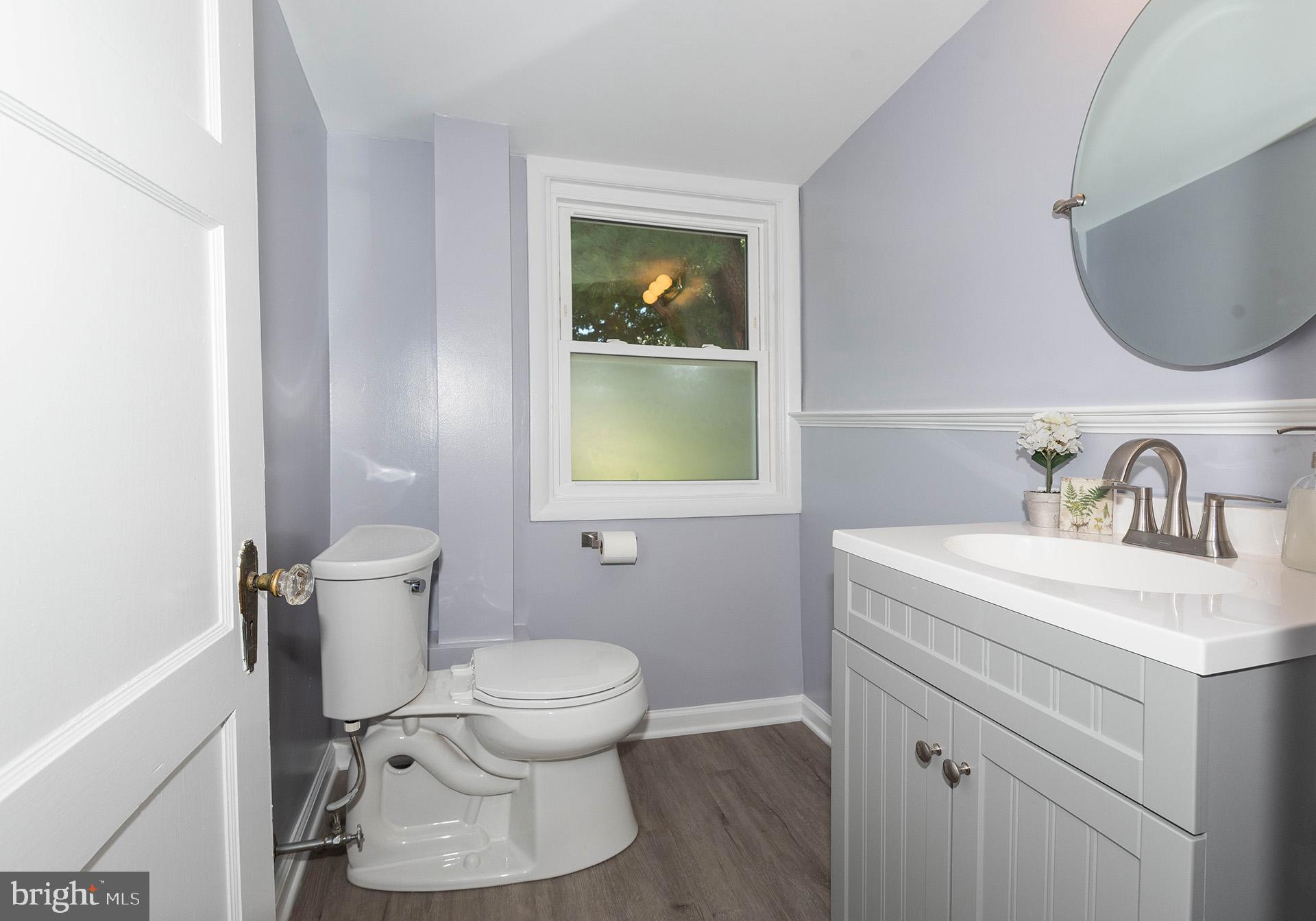 4506 Morgan Road Morningside, MD 20746 - Photo 13 of 22 a bathroom with a toilet sink and mirror